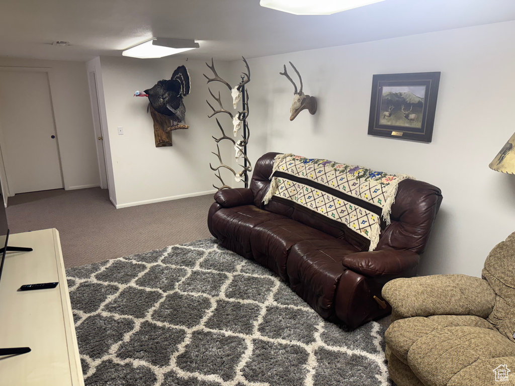 Carpeted living room featuring baseboards