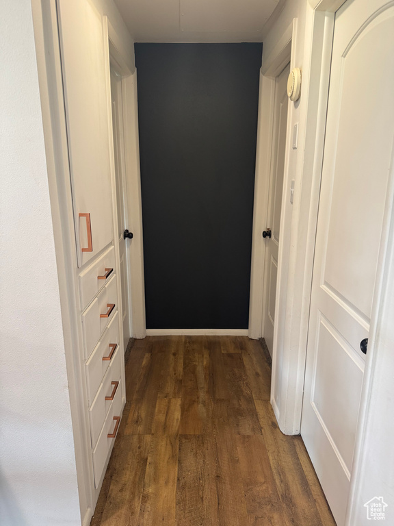 Corridor with wood finished floors and baseboards