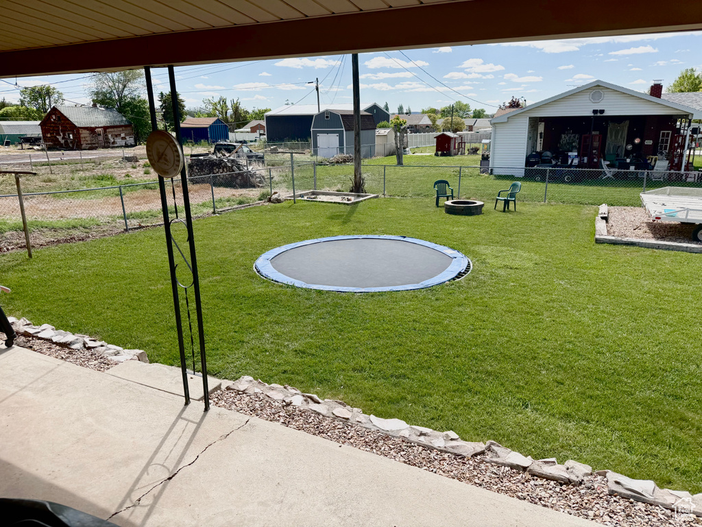 View of yard featuring a trampoline