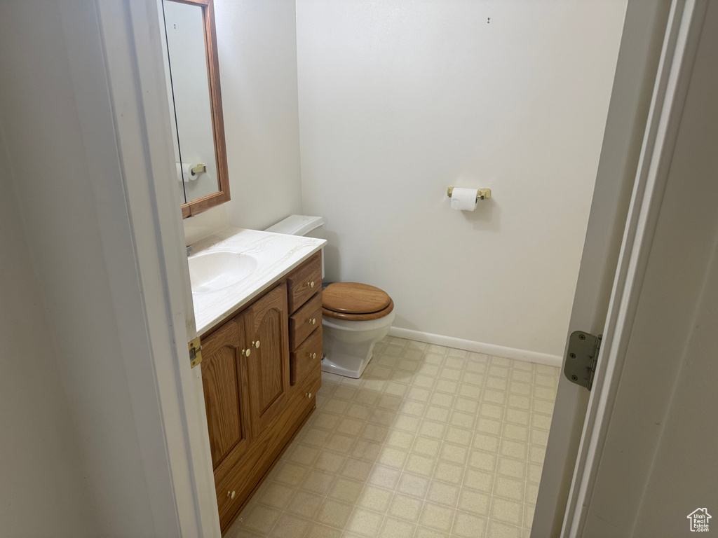 Bathroom with tile patterned floors, toilet, and vanity