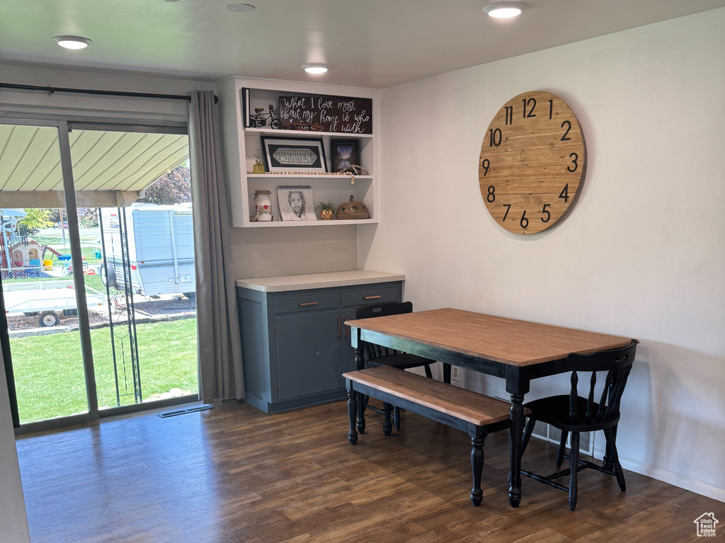 Dining room with dark wood-type flooring
