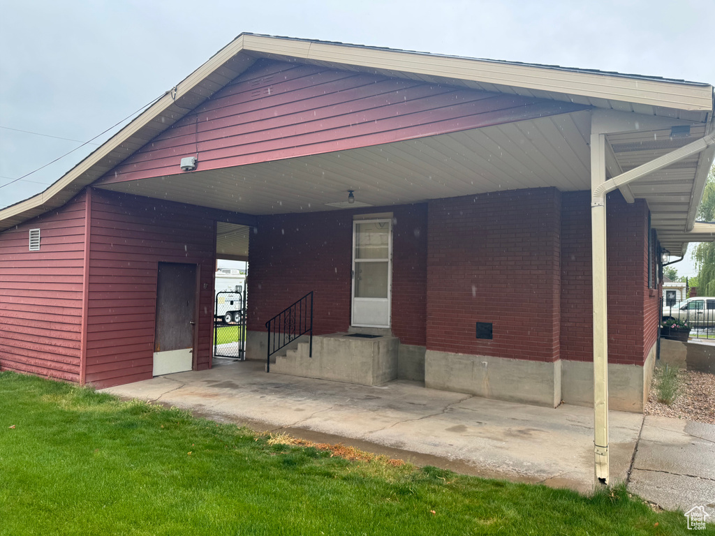 Rear view of property featuring brick siding