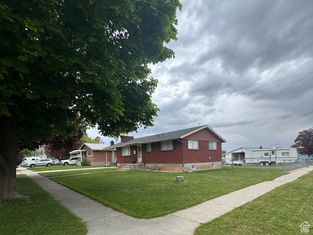 View of side of property featuring a lawn