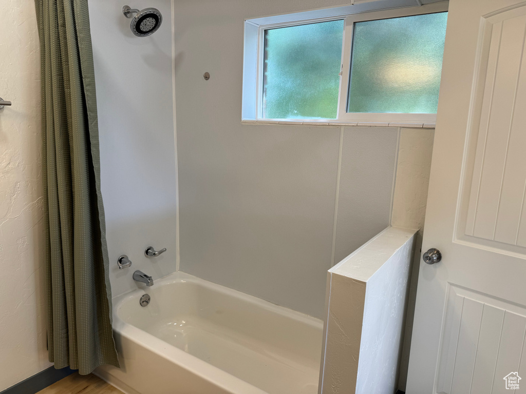 Bathroom featuring shower / bath combination with curtain