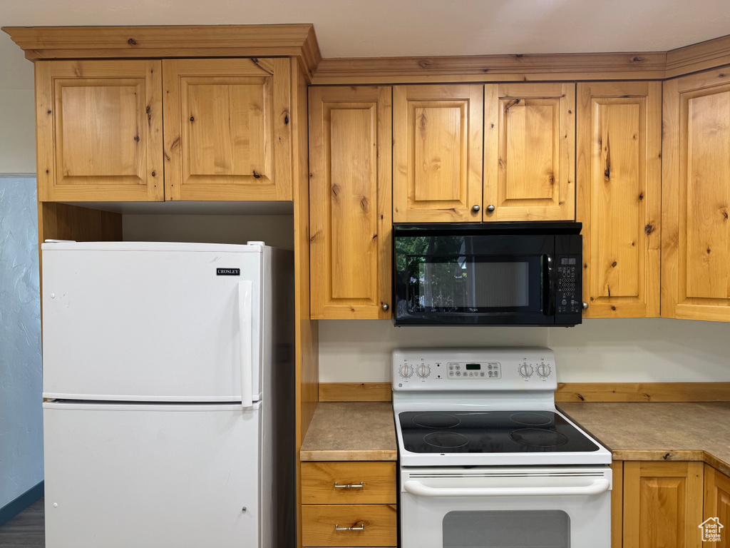 Kitchen featuring white appliances and light countertops