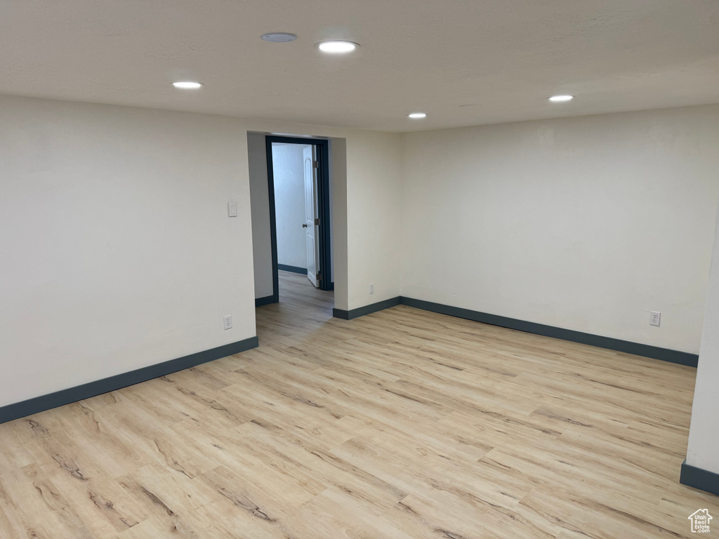 Empty room featuring light wood-type flooring, recessed lighting, and baseboards
