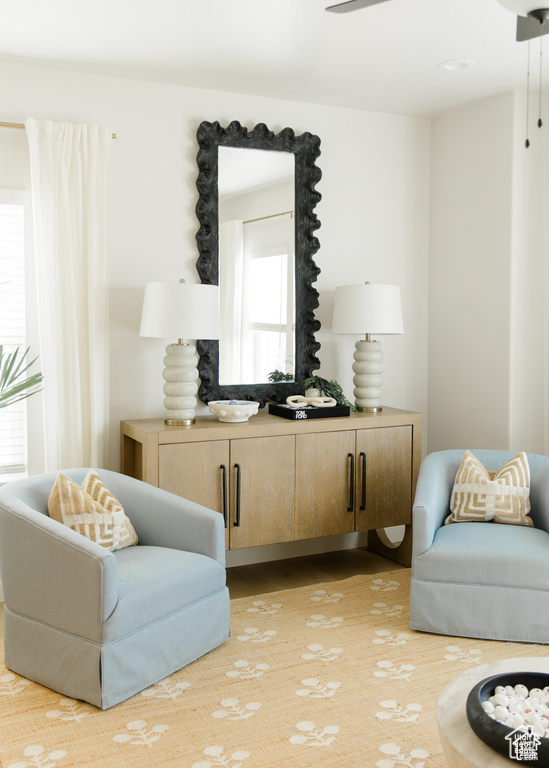 Living area featuring wood finished floors and a ceiling fan