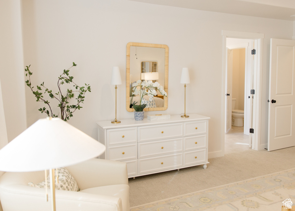 Sitting room with light colored carpet and baseboards