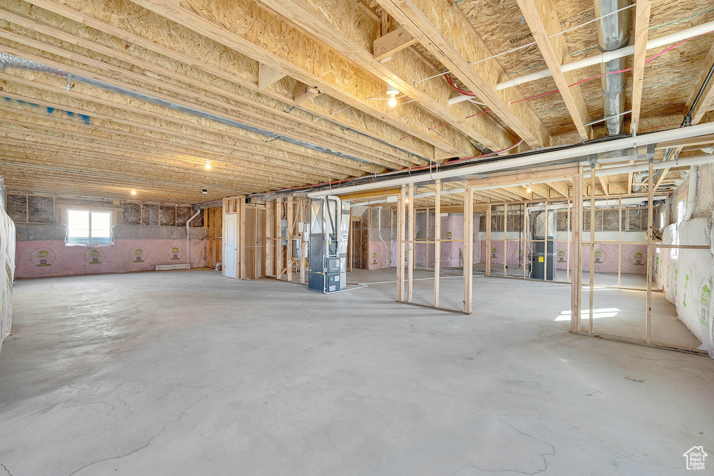 Basement featuring heating unit