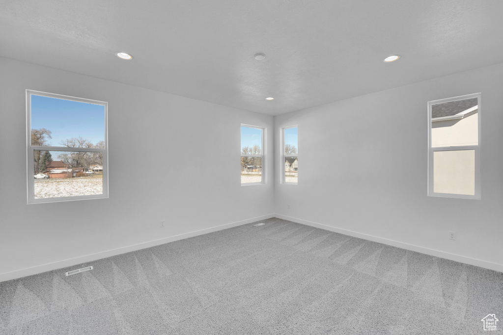 Spare room with carpet flooring, baseboards, and recessed lighting