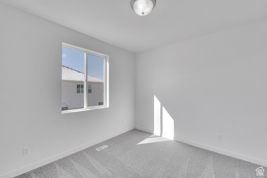 Unfurnished room featuring baseboards and carpet floors