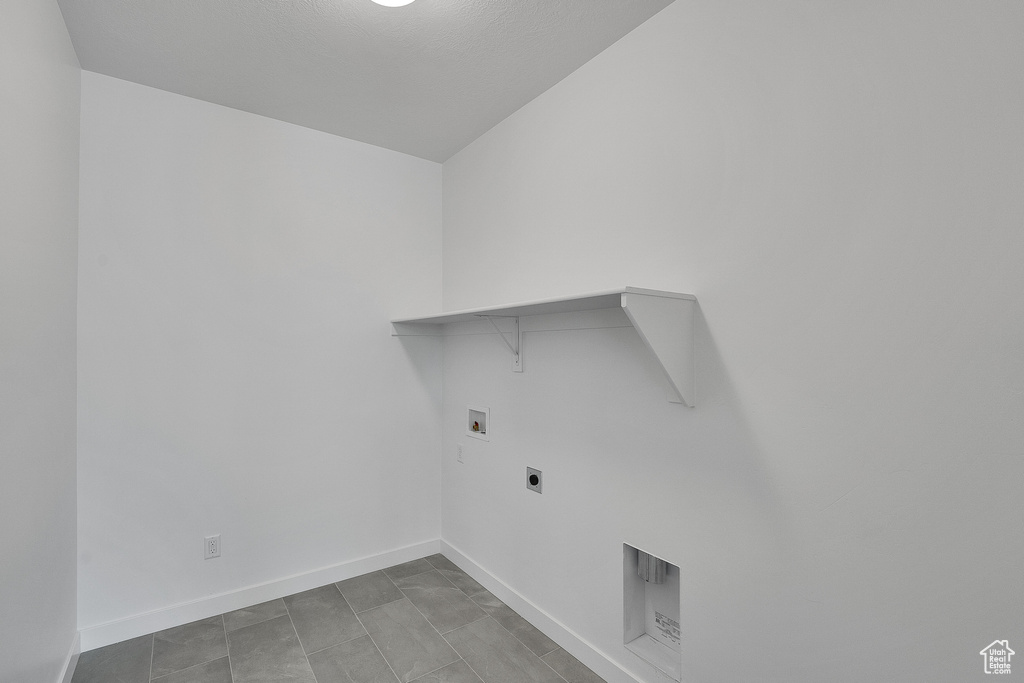 Washroom featuring hookup for a washing machine, hookup for an electric dryer, and baseboards