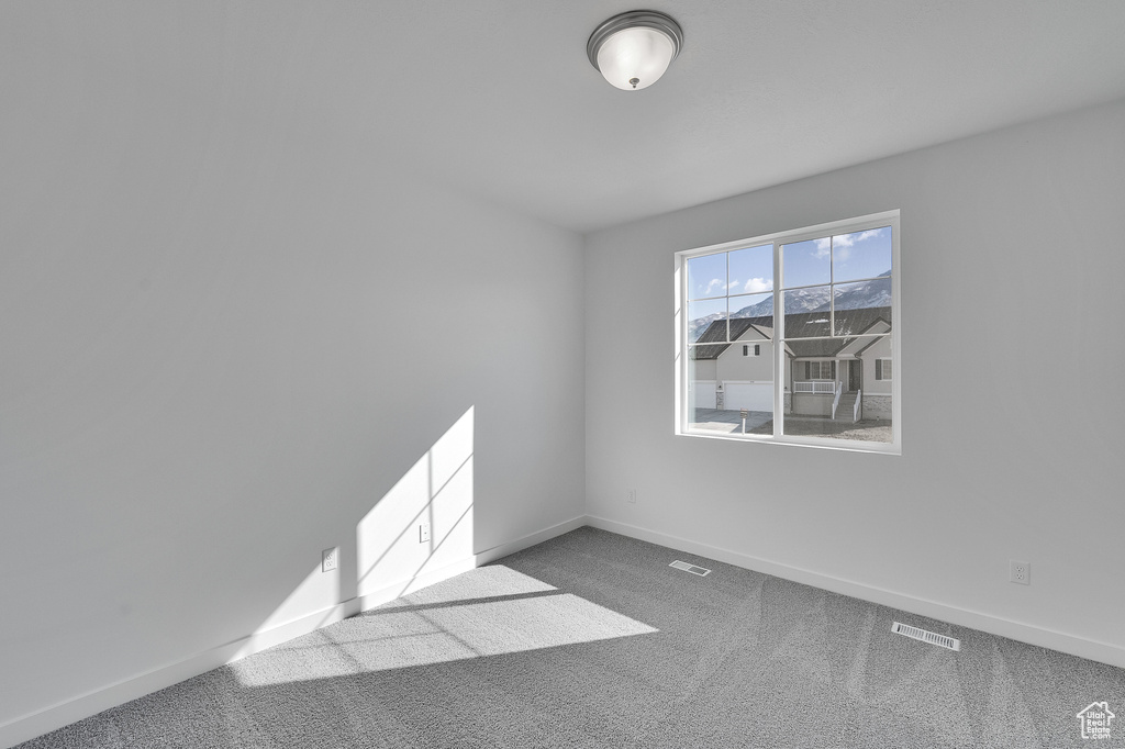 Empty room with baseboards and carpet flooring