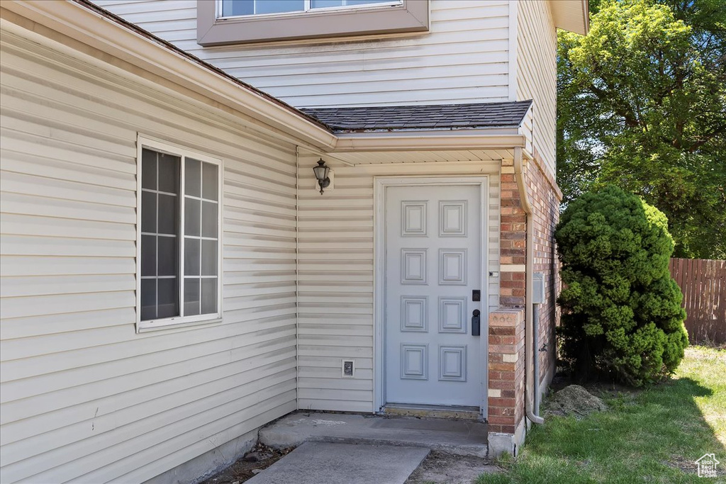 Property entrance with a shingled roof