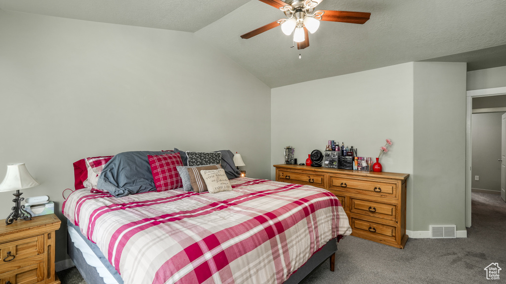 Bedroom with carpet, vaulted ceiling, a ceiling fan, and baseboards