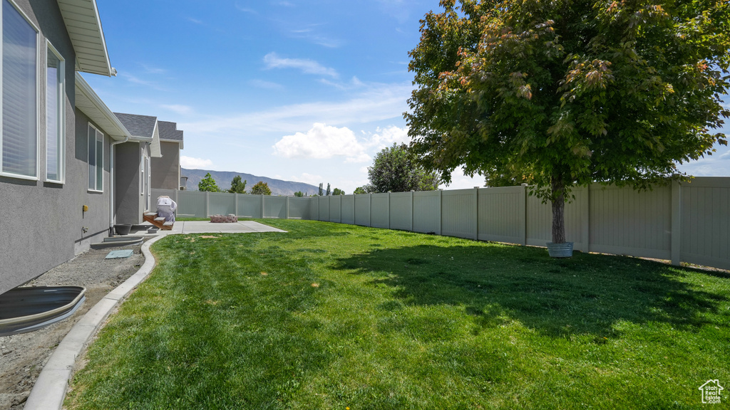 View of yard with a patio and a mountain view