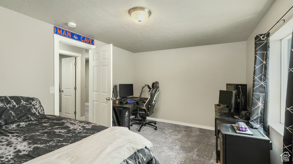 Bedroom with carpet, a desk, and baseboards