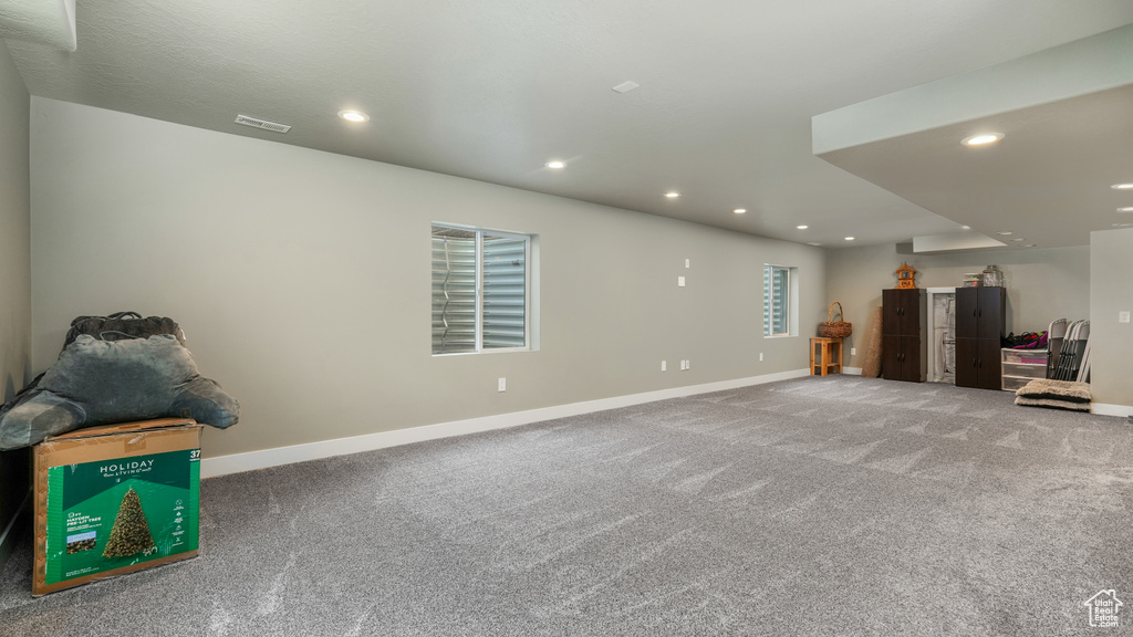 Below grade area with baseboards, carpet, and recessed lighting