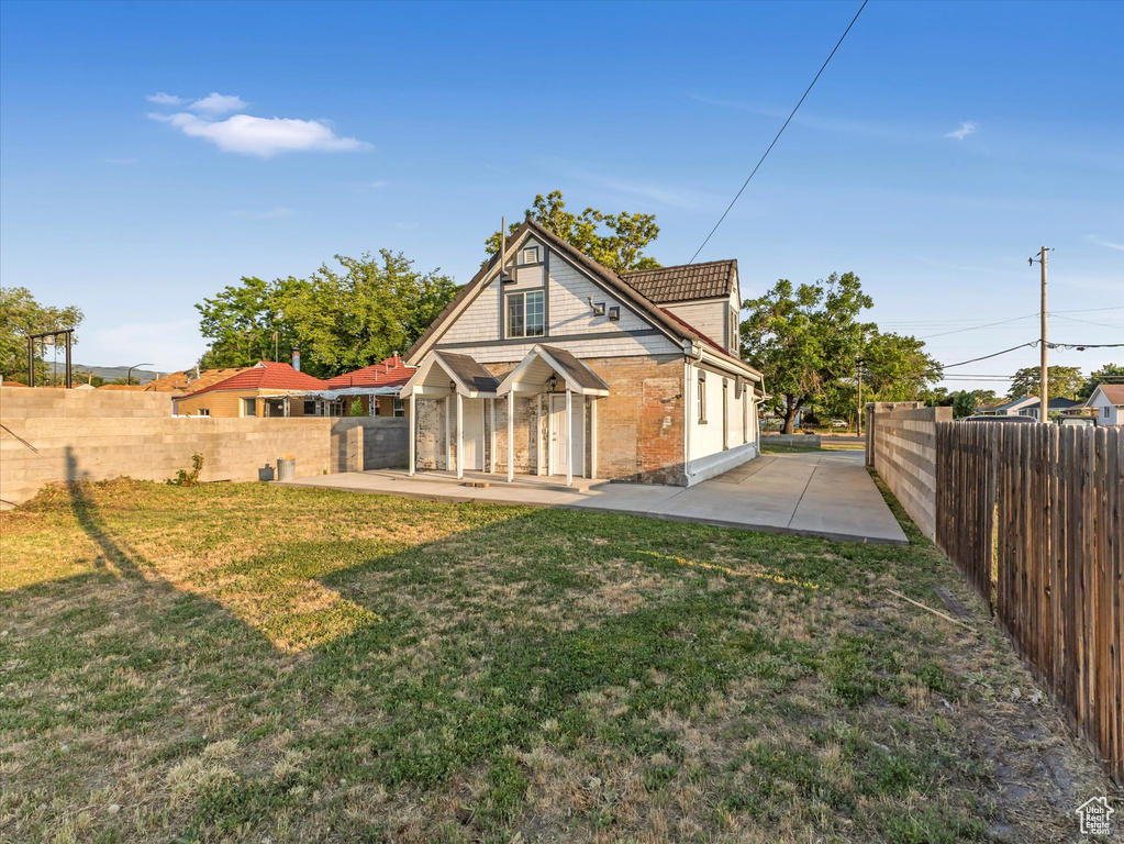 Back of house featuring a patio and brick siding