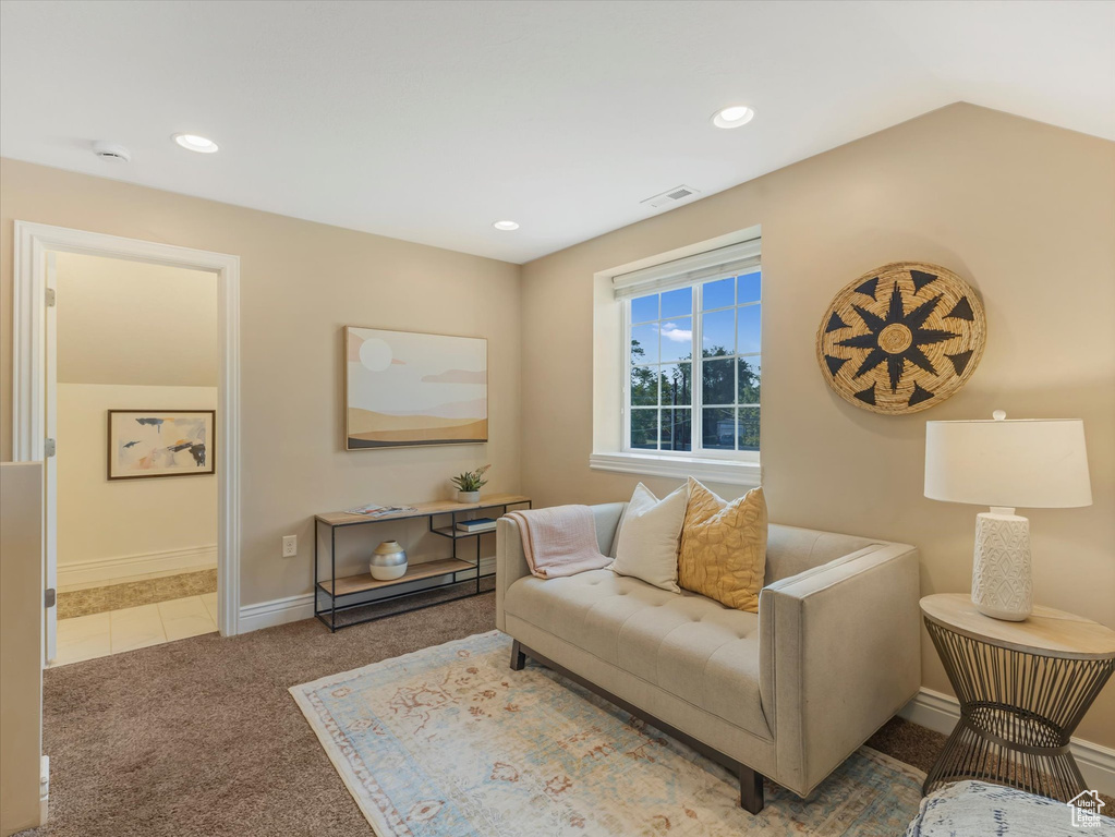 Tiled living area featuring carpet floors, baseboards, and recessed lighting