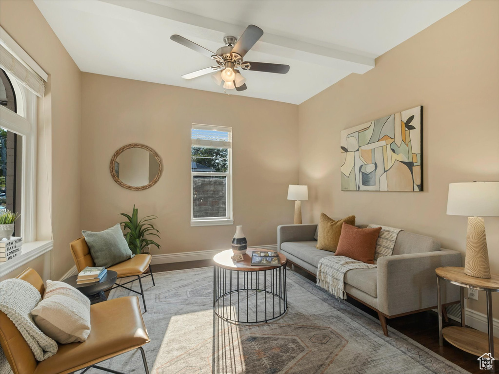 Living room with wood finished floors, baseboards, and ceiling fan