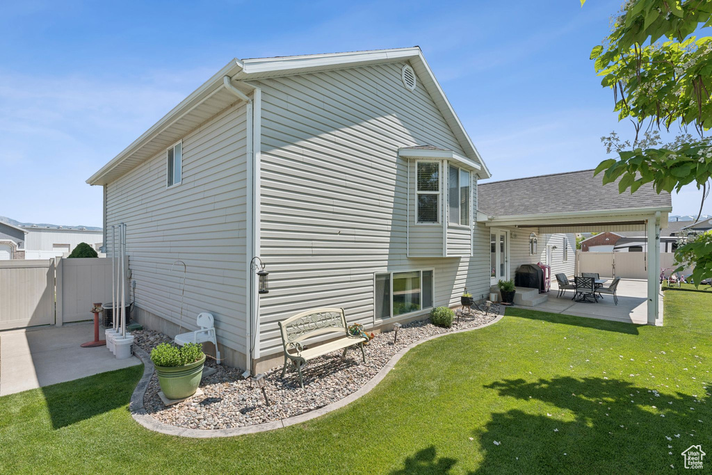 Back of property featuring a patio area and a gate