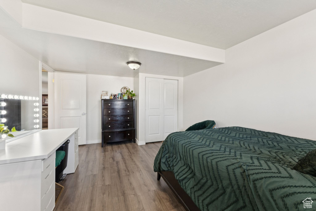 Bedroom featuring wood finished floors and a closet