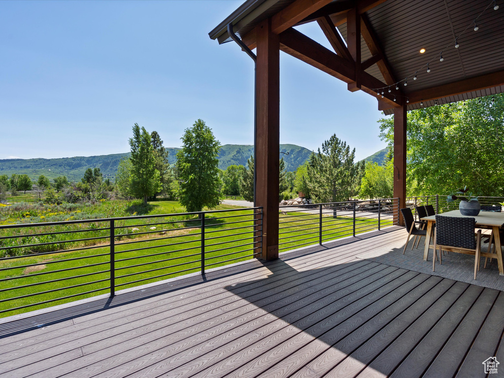 Deck featuring a mountain view and outdoor dining area