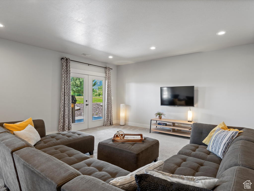 Living area featuring carpet, recessed lighting, french doors, and baseboards