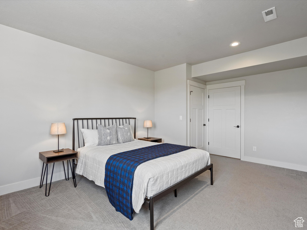 Carpeted bedroom featuring baseboards and recessed lighting