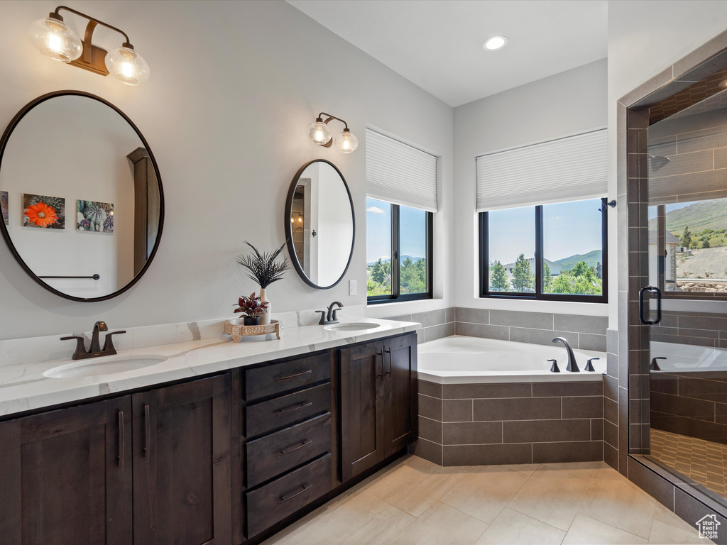 Bathroom featuring a bath, healthy amount of natural light, and a stall shower