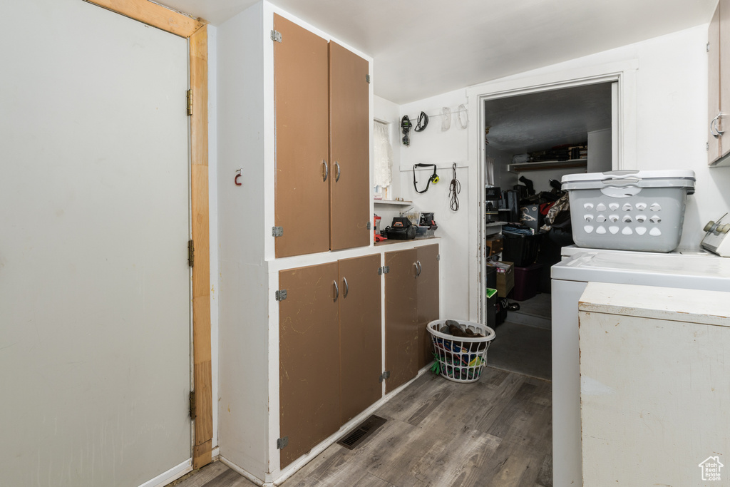 Laundry room featuring wood finished floors and independent washer and dryer