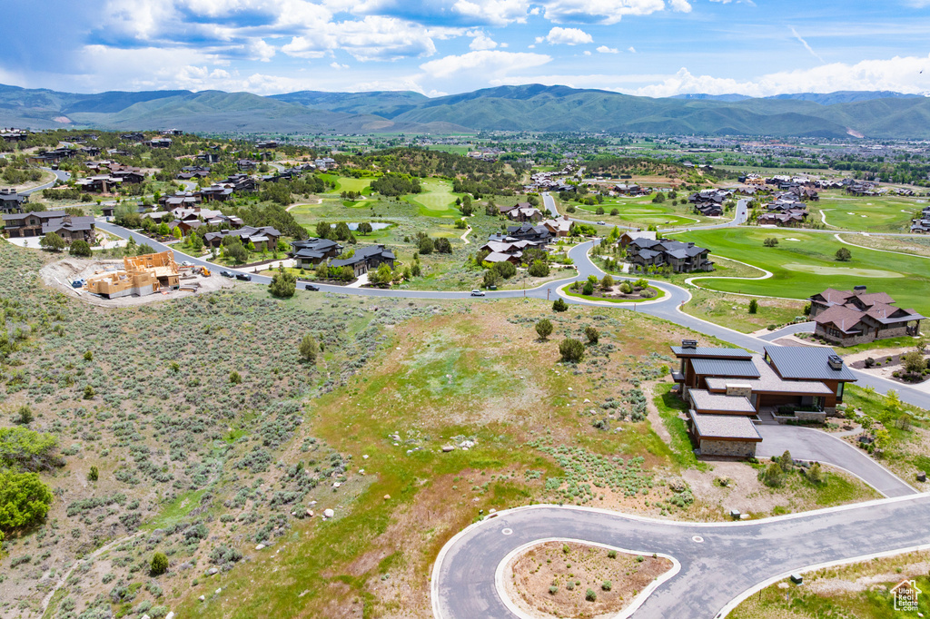 Aerial view of residential area featuring mountains and a golf course