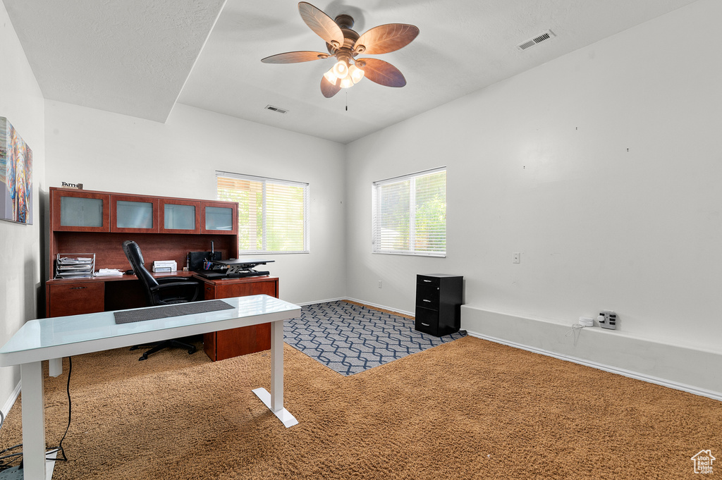 Home office with carpet flooring, ceiling fan, and baseboards