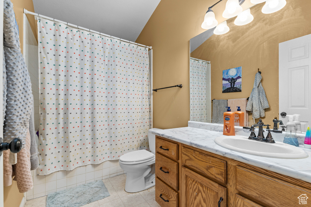 Bathroom featuring vanity, toilet, and tile patterned floors