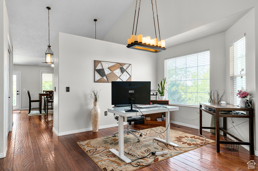 Office with hardwood / wood-style flooring, baseboards, and high vaulted ceiling
