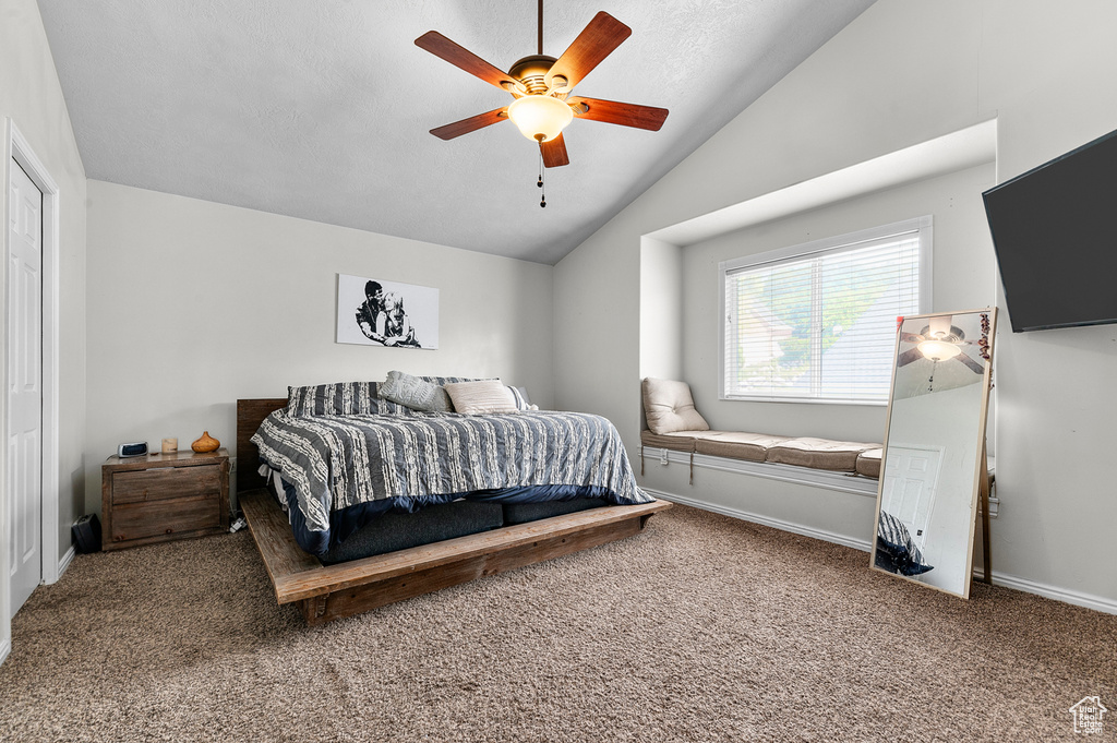 Bedroom featuring vaulted ceiling, carpet, a ceiling fan, and baseboards