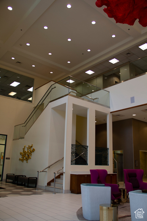 Building lobby featuring a high ceiling, recessed lighting, and stairway