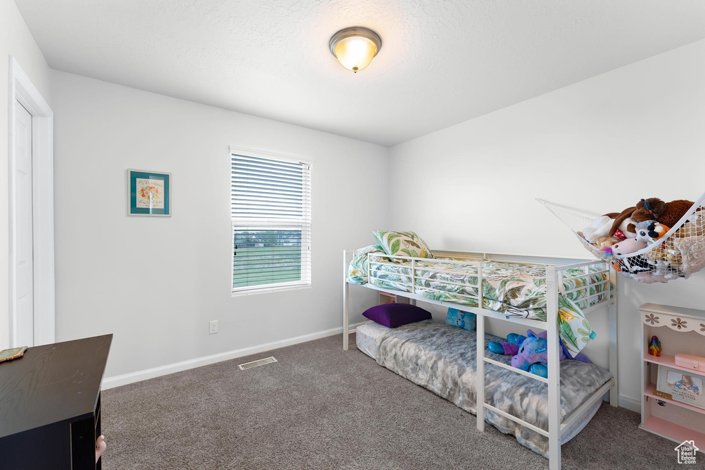 Carpeted bedroom featuring baseboards