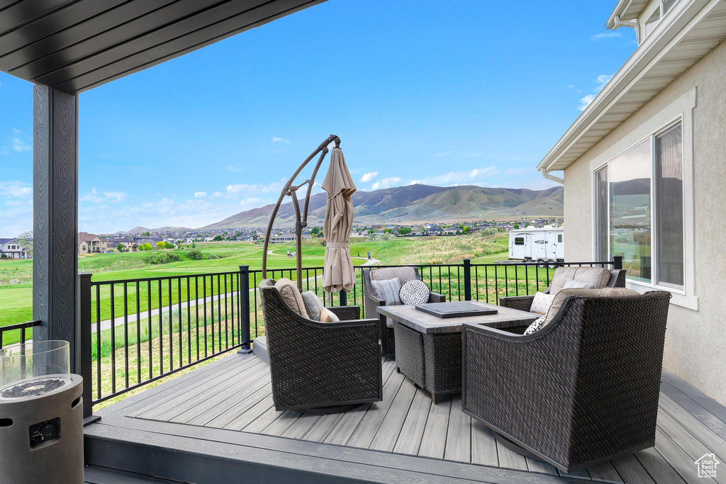 Wooden terrace with a mountain view and a lawn