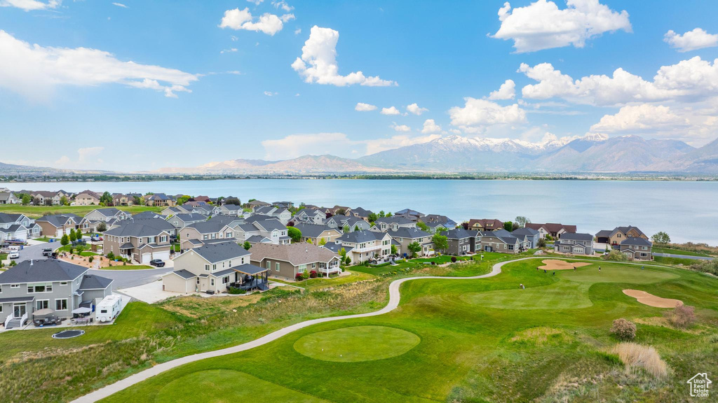 Aerial view of residential area with a water and mountain view and a local golf course