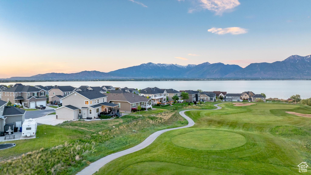 Aerial view of residential area featuring a water and mountain view and a golf club
