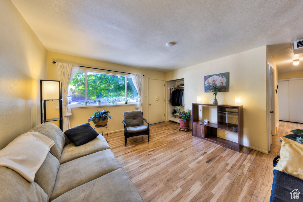Living area with wood finished floors and baseboards