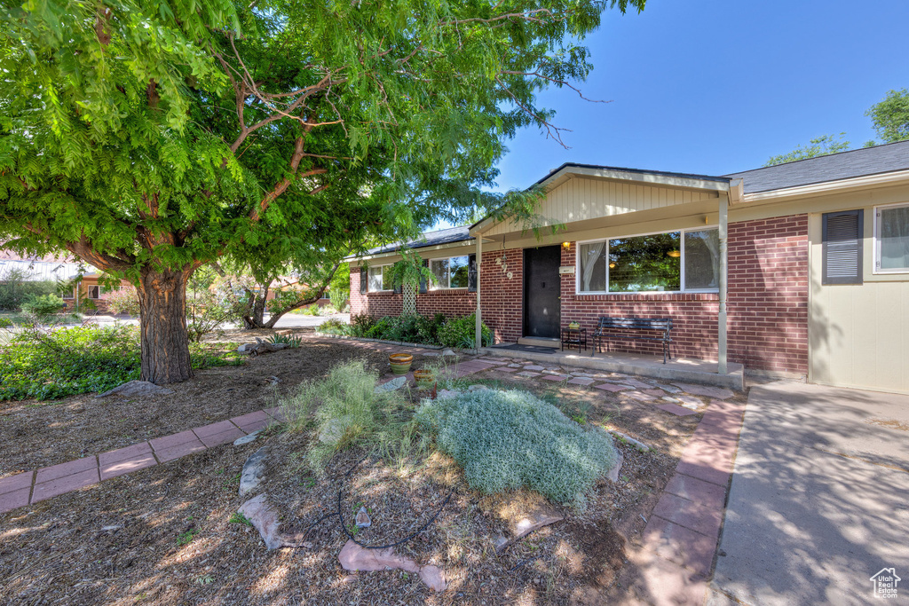 Single story home featuring brick siding