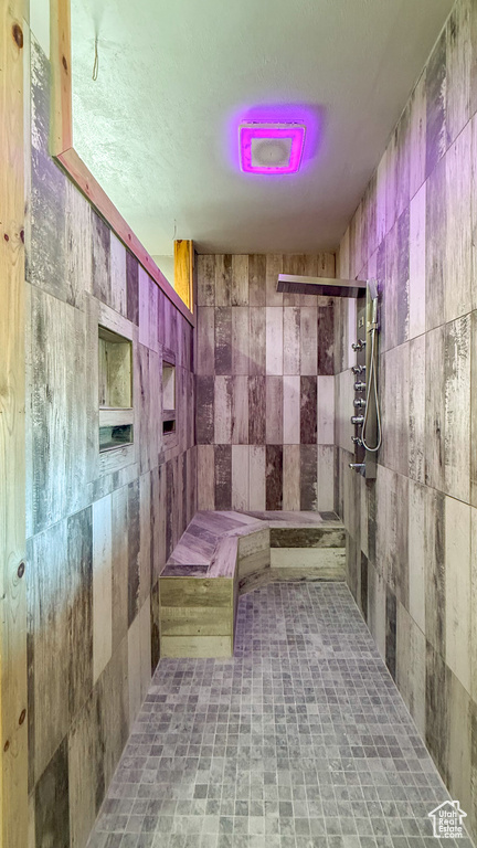 Full bath featuring a tile shower