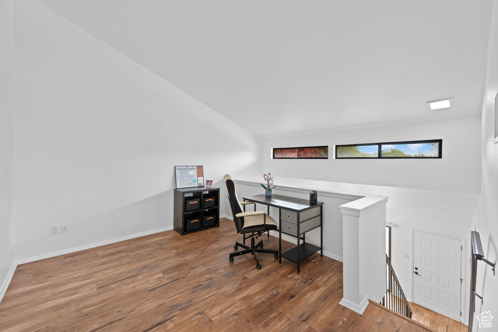 Office space with wood finished floors and baseboards