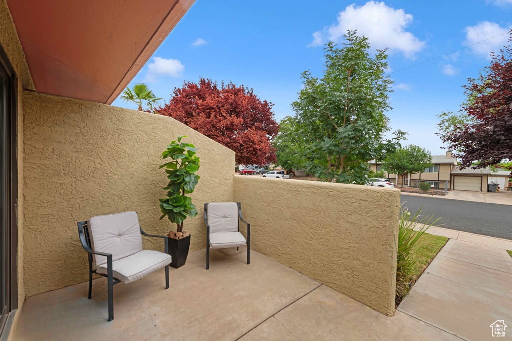 View of patio with a balcony