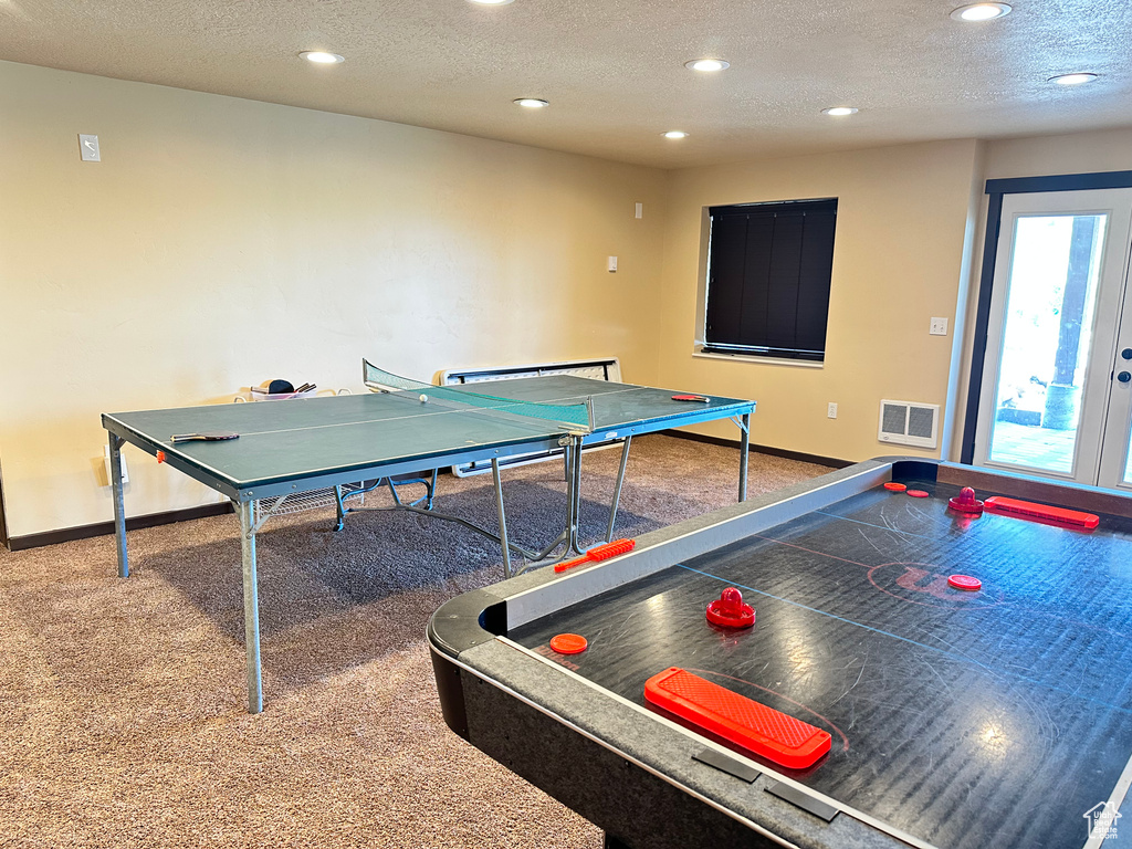 Recreation room featuring recessed lighting, baseboards, carpet flooring, and a textured ceiling