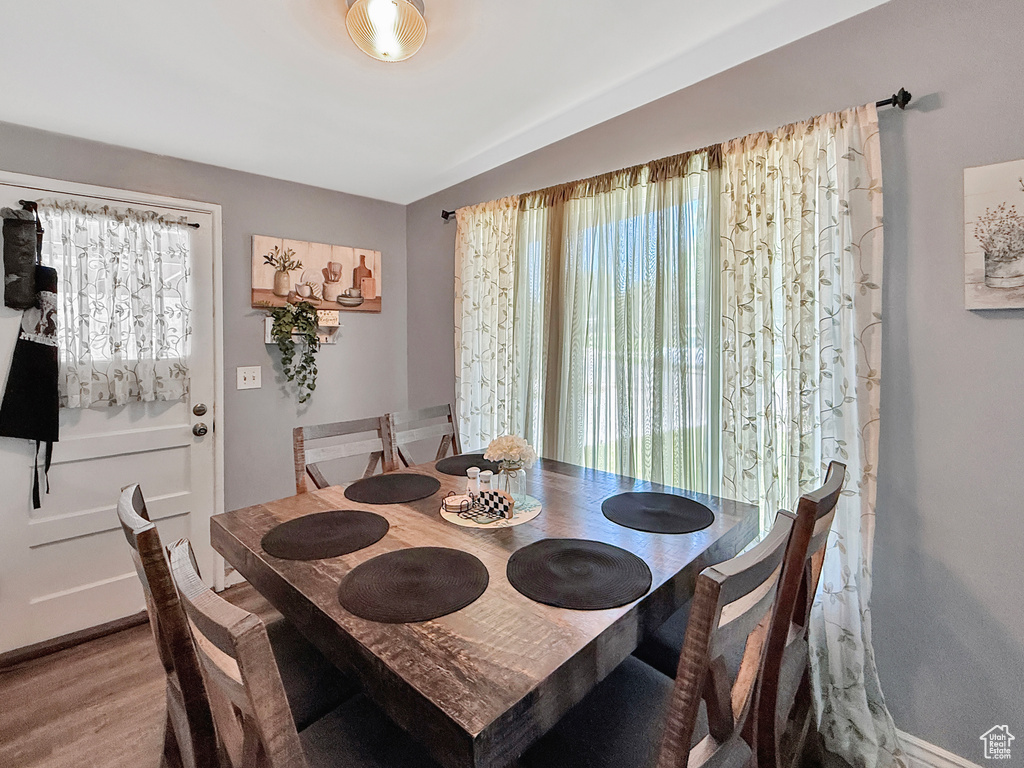 Dining space with plenty of natural light and wood finished floors