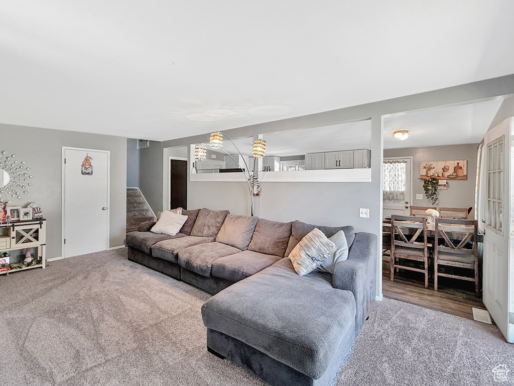Carpeted living area with stairway